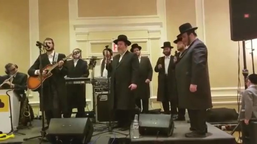 Dovy Meisels sings by a chuppah with pinky Weber and mezamrim choir